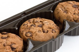Commercial chocolate chip cookies in plastic tray.