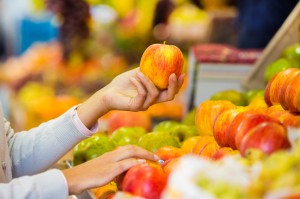 Woman buys fruits and vegetables at a market