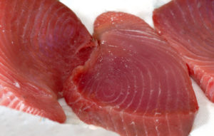 thick succulent tuna steaks being prepared for cooking
