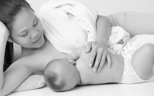 Black and white shot of woman breastfeeding baby