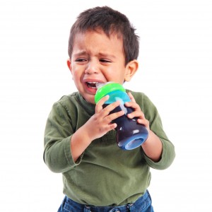 Upset Sad Toddler Crying while Drinking from a Sippy Cup