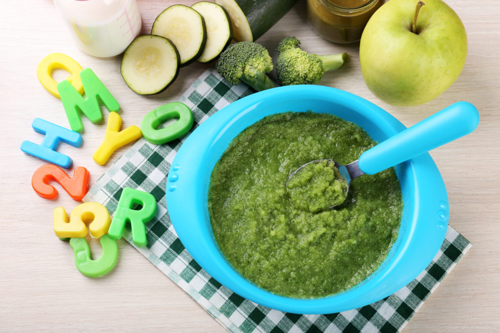 Fresh baby food in bowl with spoon